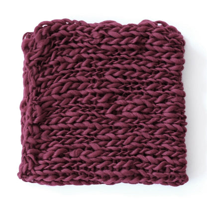 Close-up of soft textured crochet blanket, a newborn photo accessory.