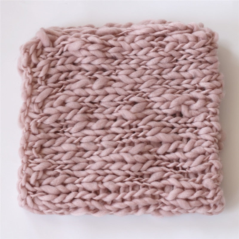 Soft white crochet baby blanket, a cute prop for newborn photo sessions.