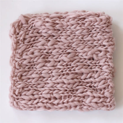 Soft white crochet baby blanket, a cute prop for newborn photo sessions.