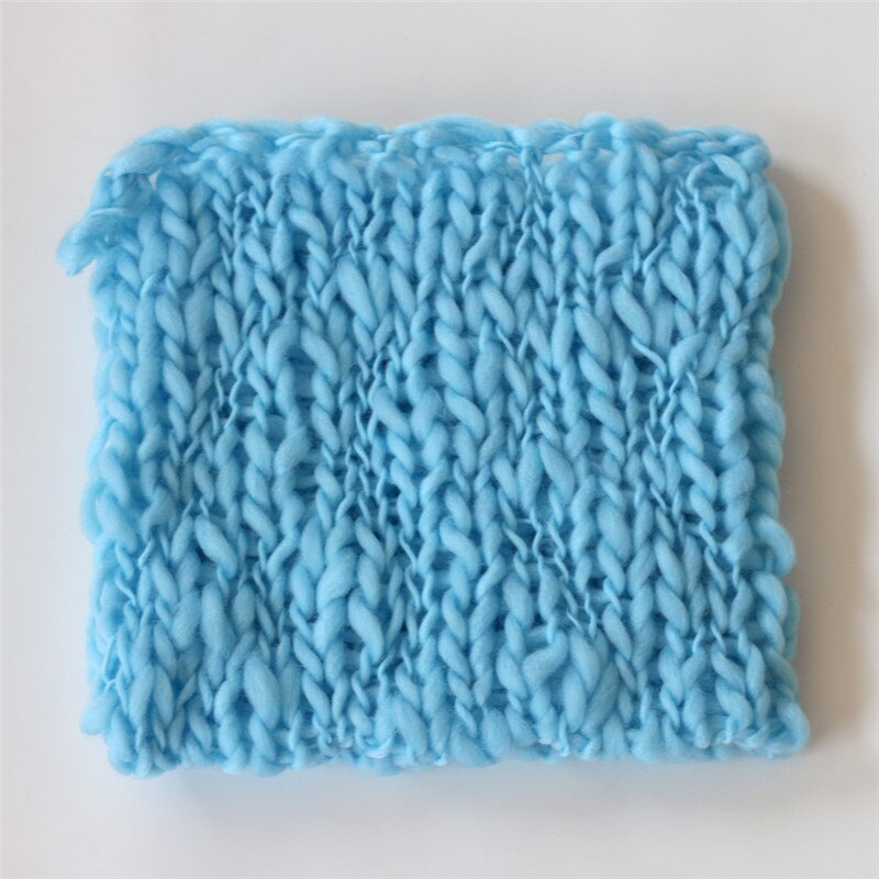 Detail view of a woven cotton blend baby blanket, perfect for infant photography.