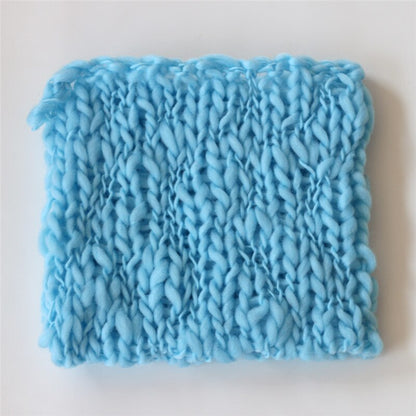 Detail view of a woven cotton blend baby blanket, perfect for infant photography.