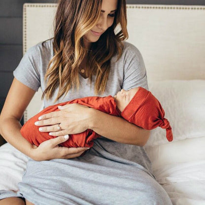 Breathable newborn swaddle with bow hat, ideal for comfortable baby sleep and photo ops