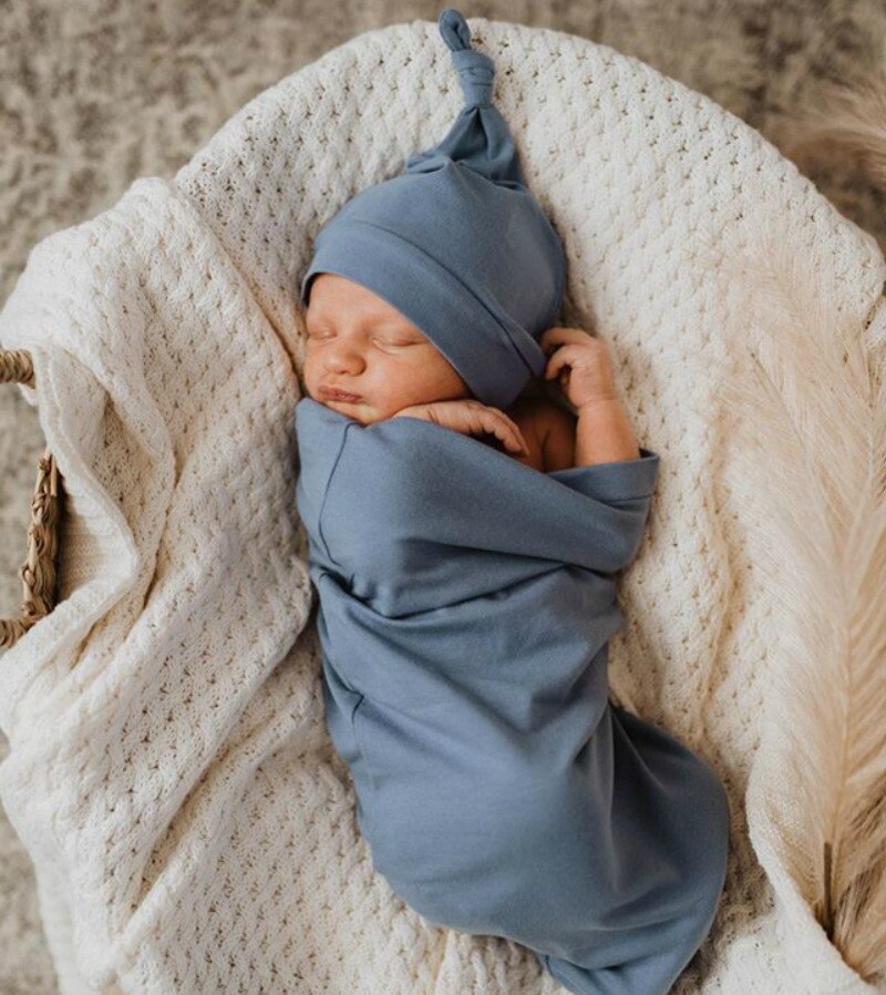Cotton newborn sleeping bag and matching hat, essential baby accessory for peaceful nights