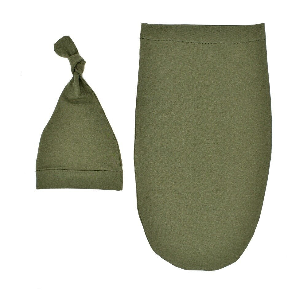 Blue newborn swaddle sleeping bag and infant hat, designed for safe and snug baby sleep