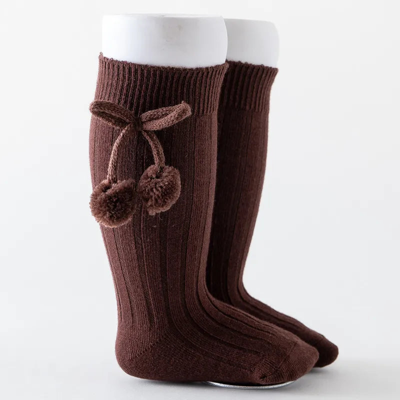 Unisex grey soft knit knee-high baby socks, versatile infant apparel.