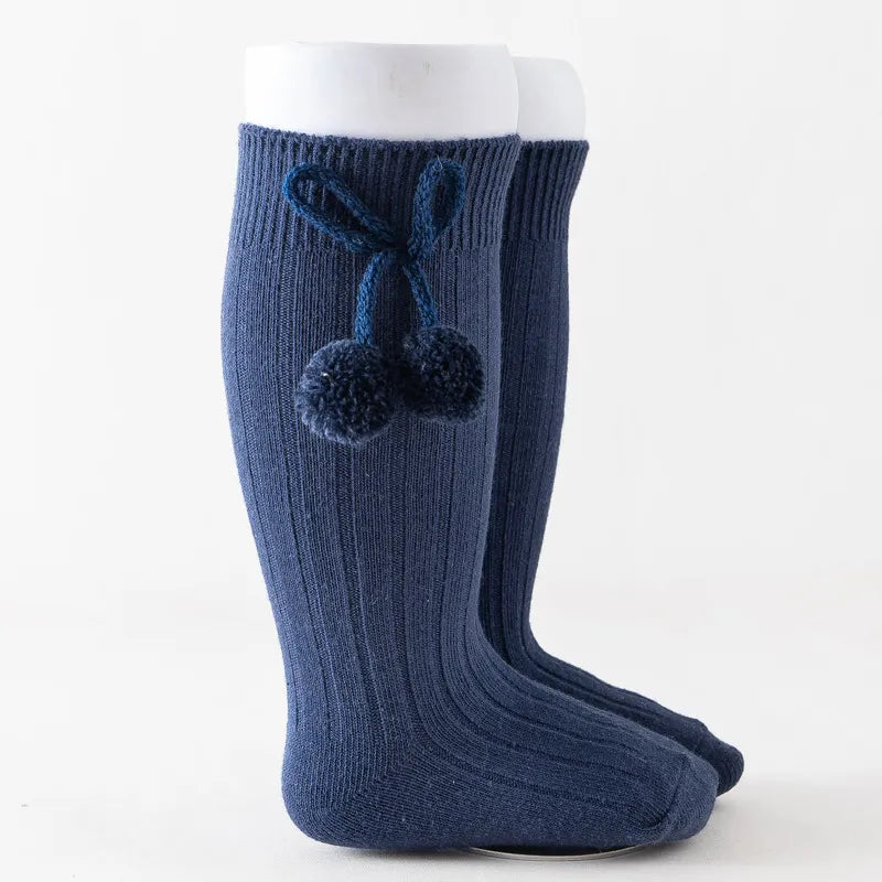 Textured soft knit knee-high baby socks, cozy and durable cotton.