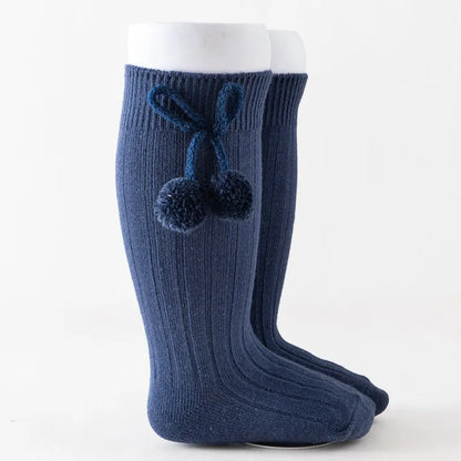 Textured soft knit knee-high baby socks, cozy and durable cotton.
