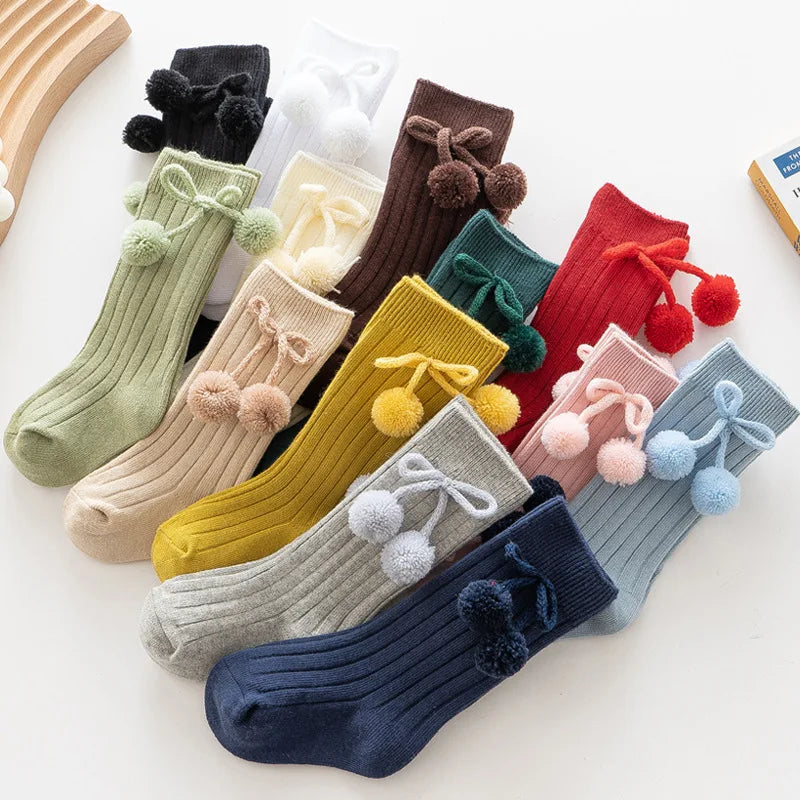 Soft knit knee-high baby socks in a gift set, perfect baby shower present.