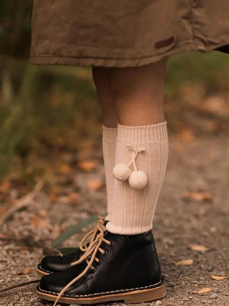 Close-up of the knit pattern on a soft knee-high baby sock, detailed.