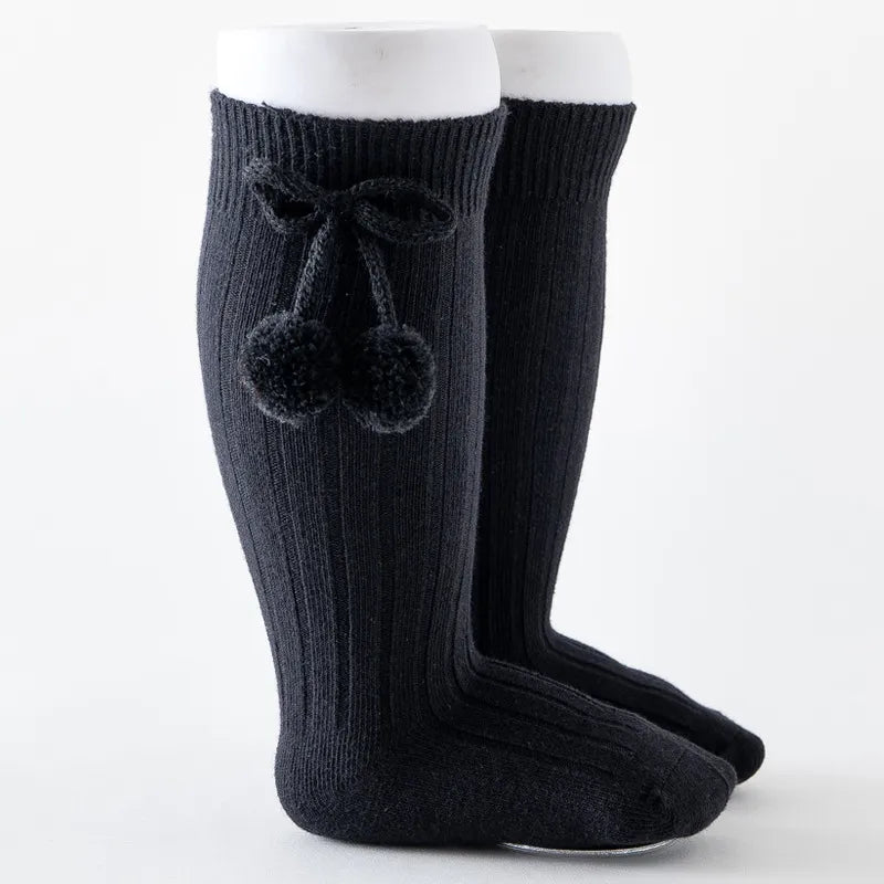 Soft knit knee-high baby socks, perfect as baby leg warmers for playtime.