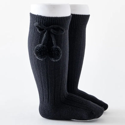 Soft knit knee-high baby socks, perfect as baby leg warmers for playtime.