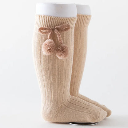 Baby boy in blue soft knit knee-high socks, perfect for warmth.