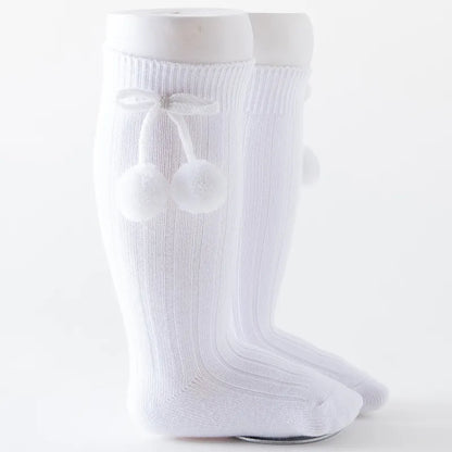 White soft knit knee-high baby socks, essential infant apparel.