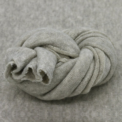 Cozy knitted baby blanket, perfect newborn photography prop, also functions as a soft studio backdrop.