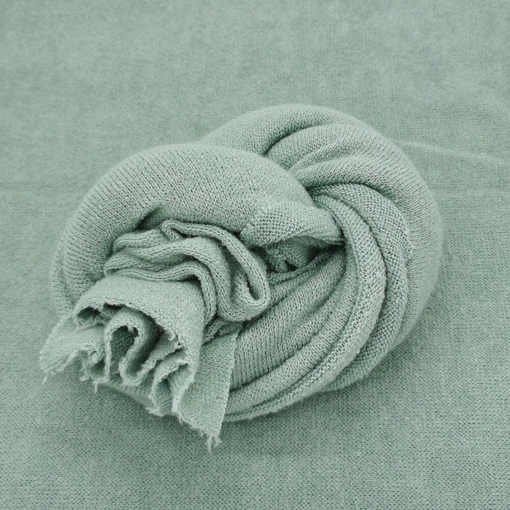 Knitted baby wrap in gentle white, perfect for newborn photoshoots, soft cotton baby prop.