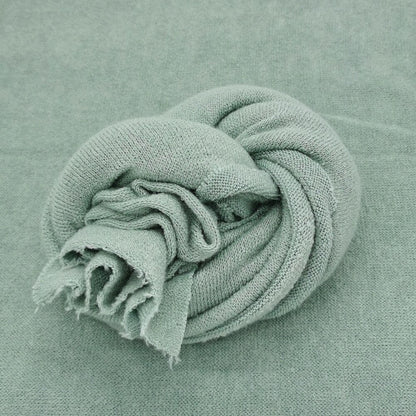 Knitted baby wrap in gentle white, perfect for newborn photoshoots, soft cotton baby prop.