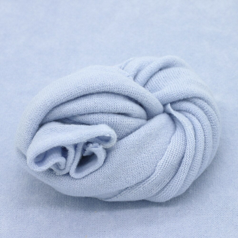 Delicate knitted baby photography prop, a comfortable wrap or backdrop for infant studio sessions.