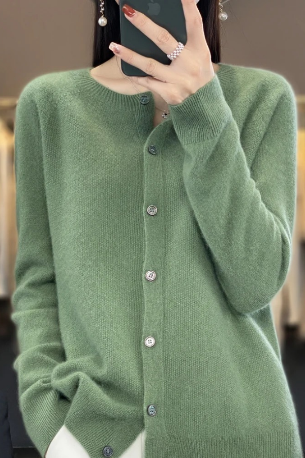 Woman layering a soft long cardigan over an outfit, showcasing its versatile fashion appeal.
