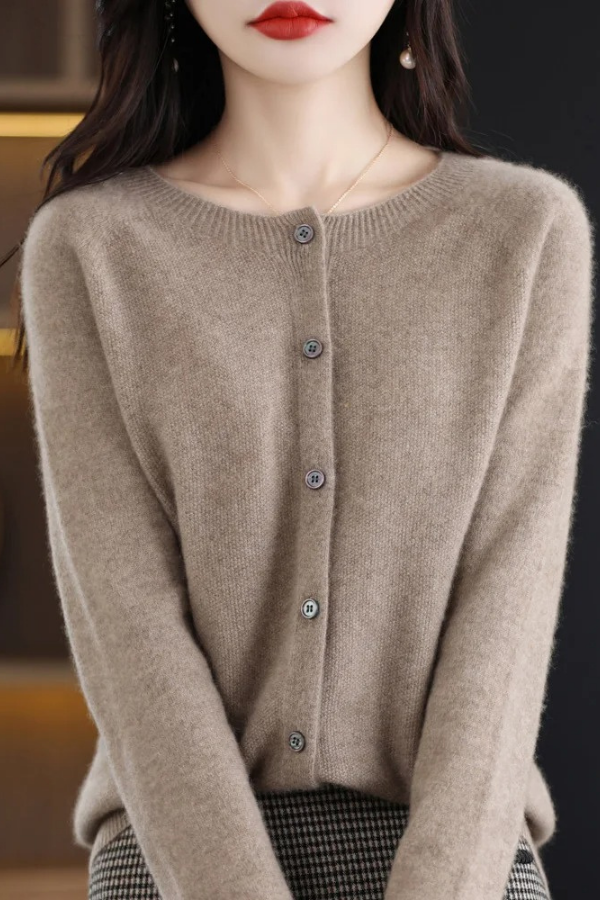 Woman models a soft long button-front cardigan, demonstrating effortless style & versatile layering.