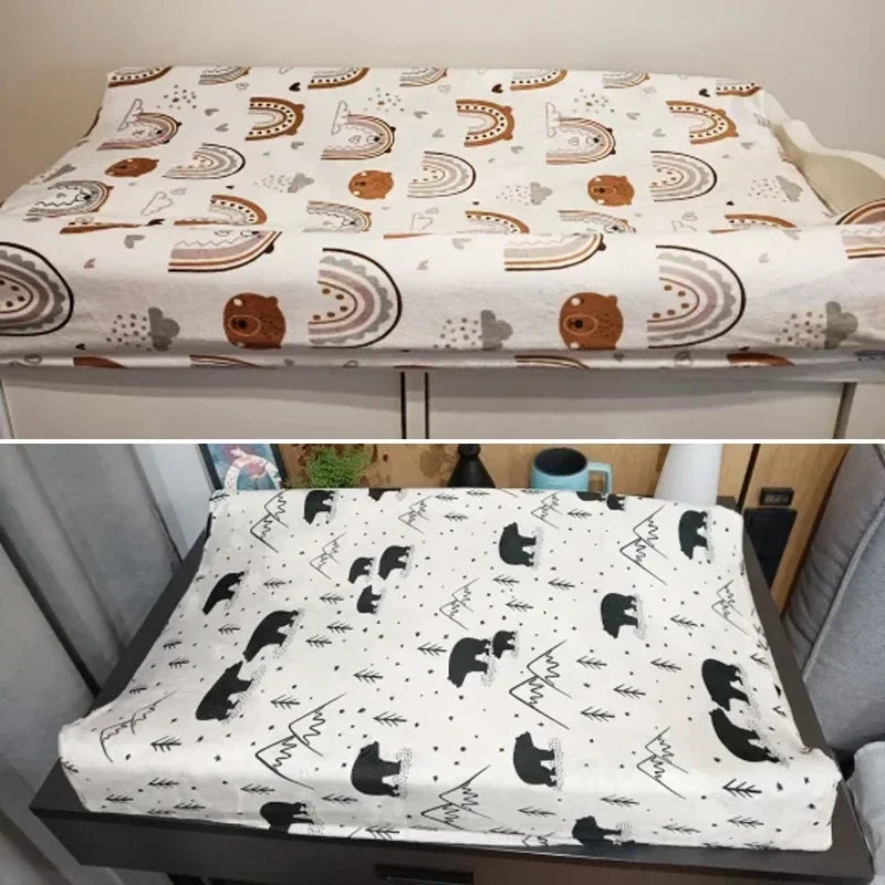 White minky changing pad cover with cute animal prints, essential baby nursery accessory.