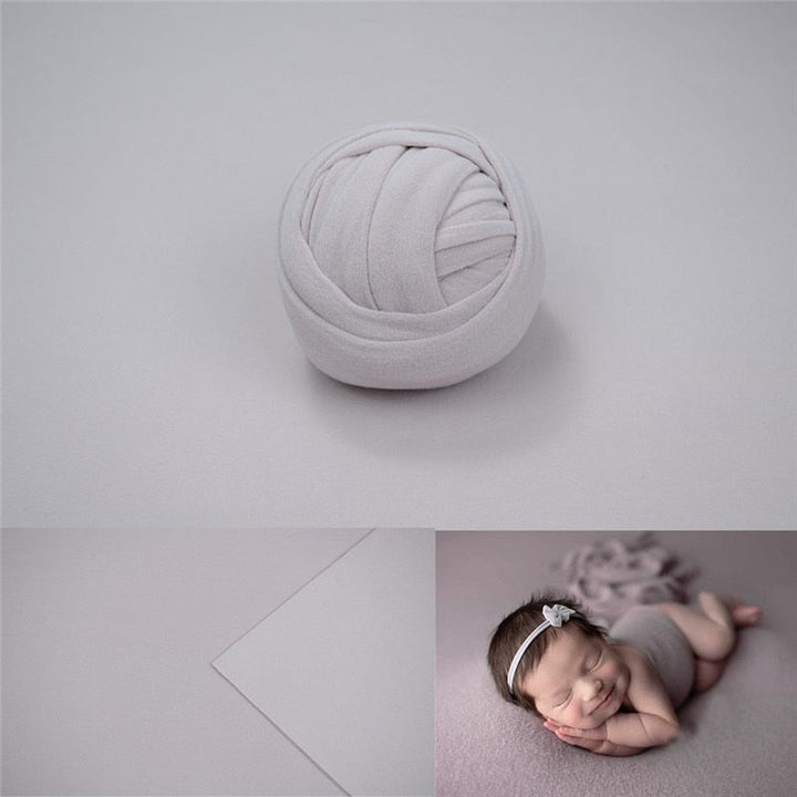 Stretchy cotton baby wrap and seamless light gray backdrop for infant photos