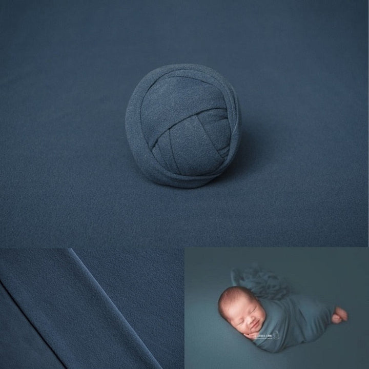 Versatile newborn wrap in light pink, paired with a subtle floral backdrop