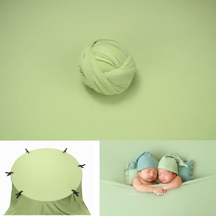 Newborn wrap for photography in a basket with a warm, cozy backdrop