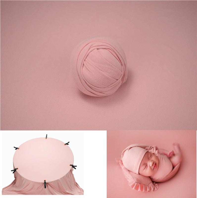 Unisex newborn wrap in light grey with a crisp white photography backdrop