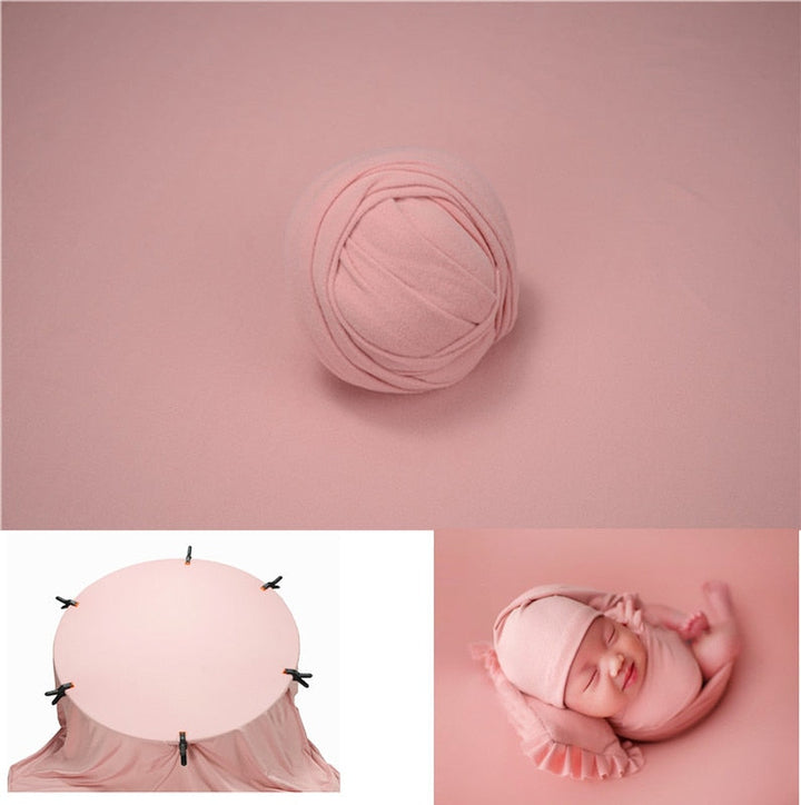 Unisex newborn wrap in light grey with a crisp white photography backdrop