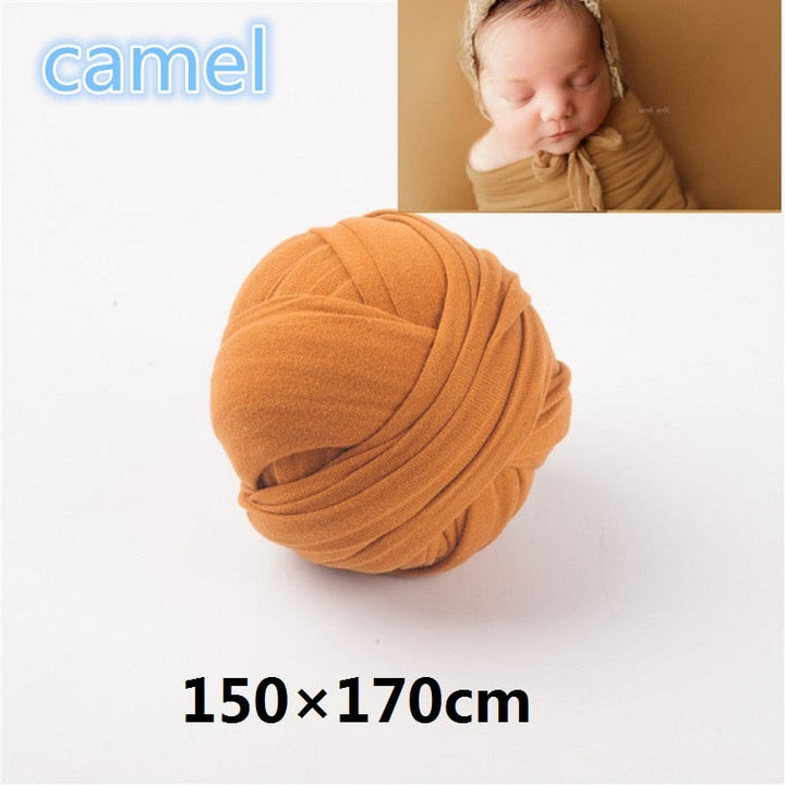 Infant wrap with a chunky knit design and a simple, elegant photography backdrop