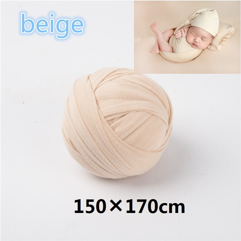 Newborn photography set: wrap in a neutral shade with a patterned backdrop