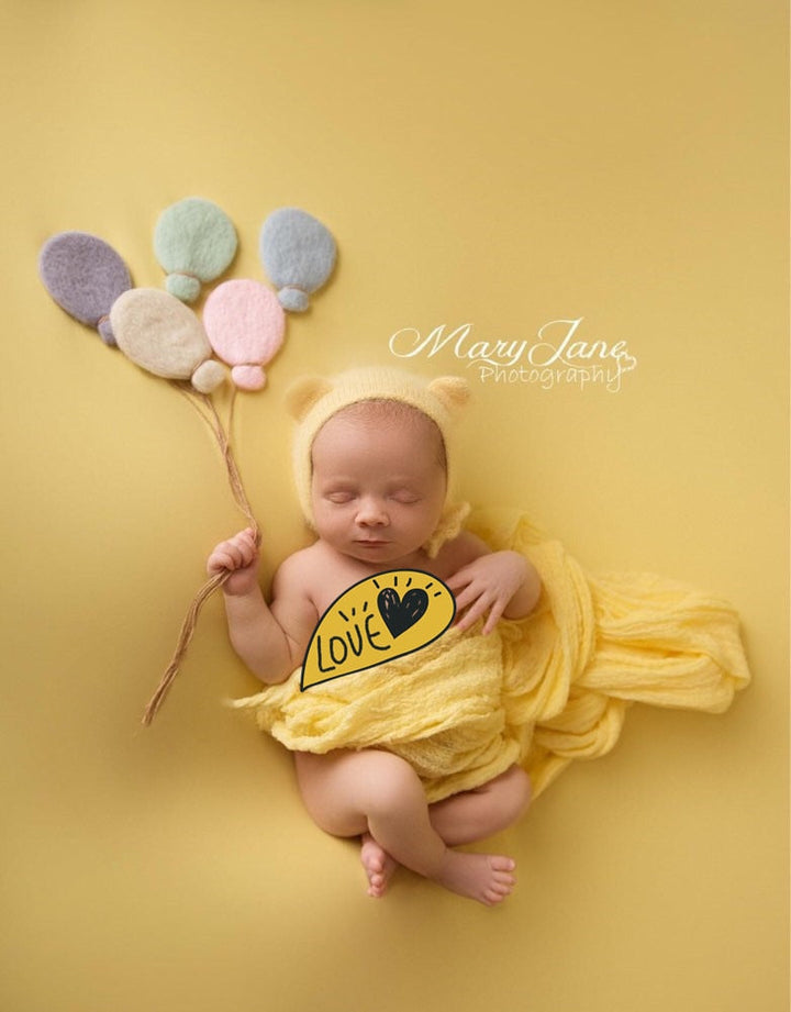 Newborn photography essentials: wrap and backdrop laid out on a clean surface