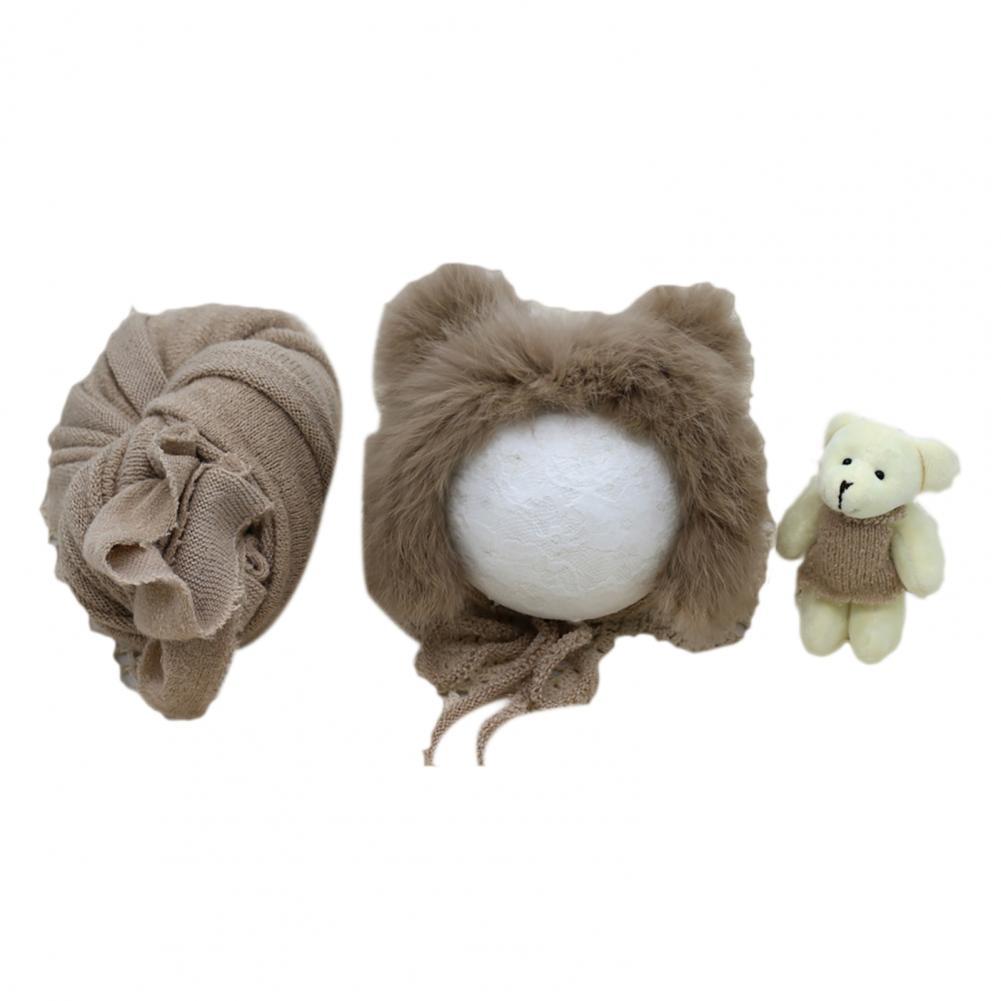 Complete newborn photography prop set: gentle swaddle blanket, matching hat, and small baby doll.
