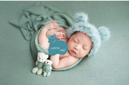 Newborn photography prop set: cozy swaddle blanket, tiny hat, and cute matching doll for infants.