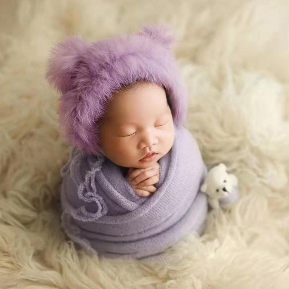 Adorable newborn swaddle blanket, hat, and doll set, perfect baby shower gift or photography prop.
