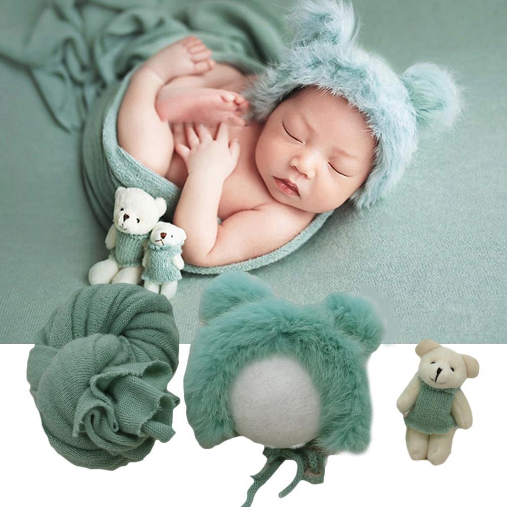 Infant swaddle blanket, hat, and doll photography prop package in a neutral, soft cotton blend.