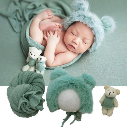 Infant swaddle blanket, hat, and doll photography prop package in a neutral, soft cotton blend.