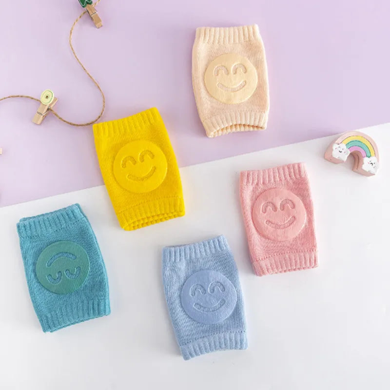 Soft pink baby crawling knee pads, perfect for infant leg warmth and protection on hard floors.