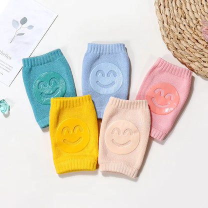 Collection of newborn essentials: soft knee pads in various pastel colors for gentle protection.