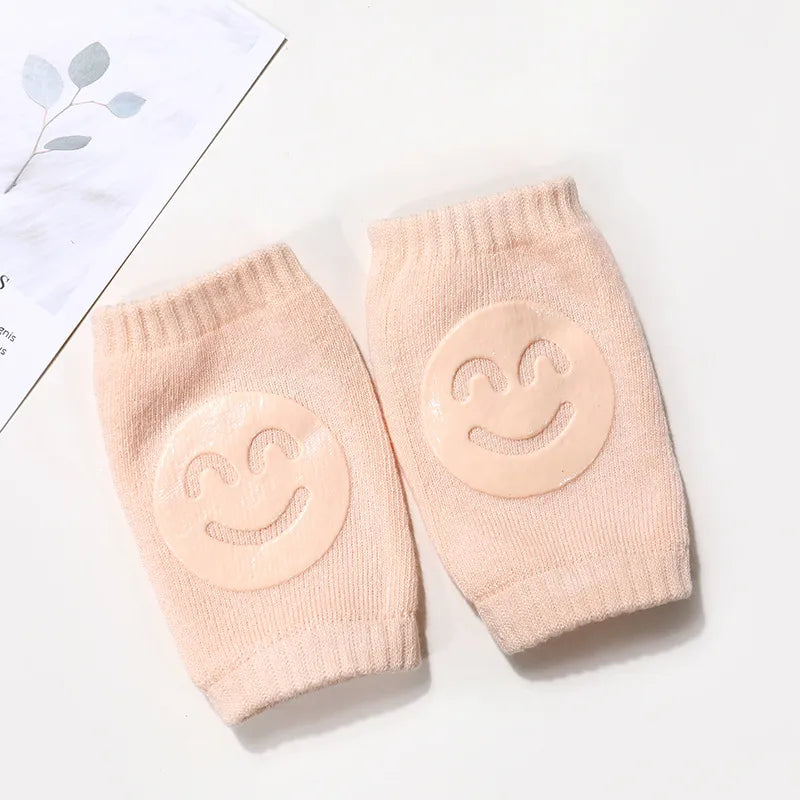 Baby wearing beige crawling protector knee pads, showcasing their flexible and soft design.