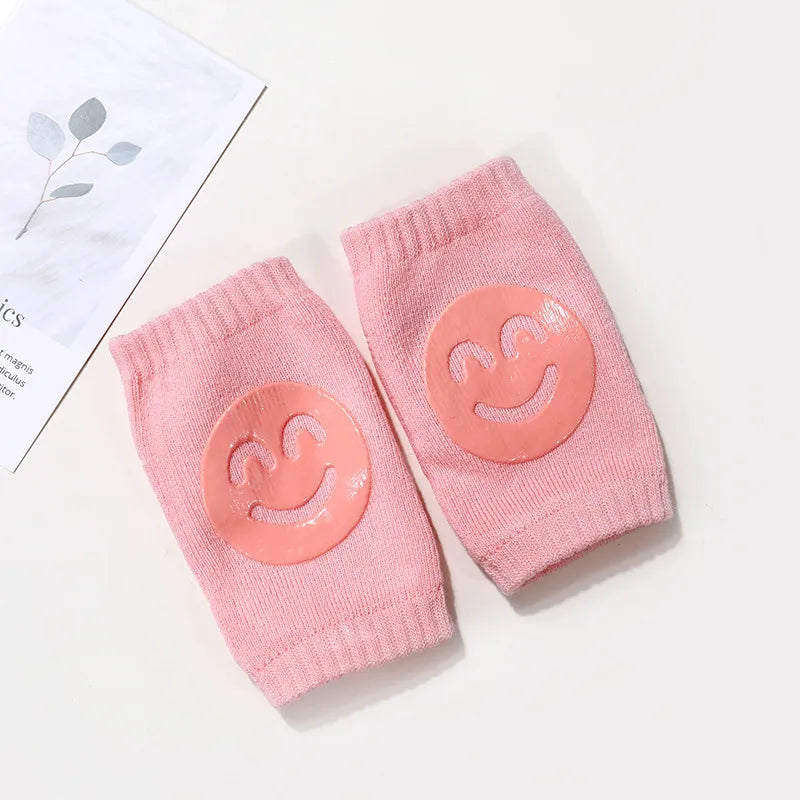 Orange crawling knee pads for babies, designed to prevent scrapes and bruises during exploration.