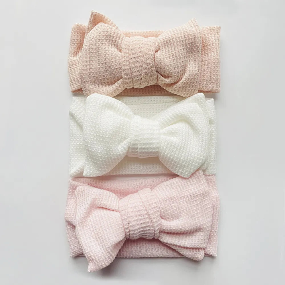 Soft pink cotton baby girl headband with bow, perfect for infants