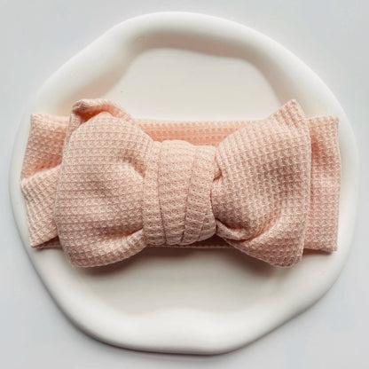 Stylish baby girl's outfit completed with a mint green cotton bow headband