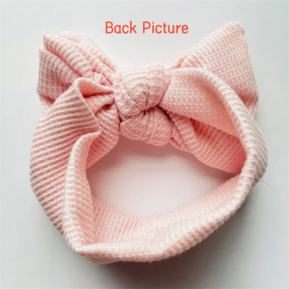 White baby girl cotton headband featuring a charming, delicate bow