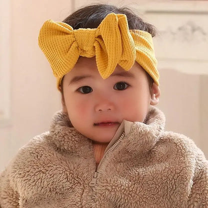 Yellow soft cotton baby headband with bow, ideal for toddlers
