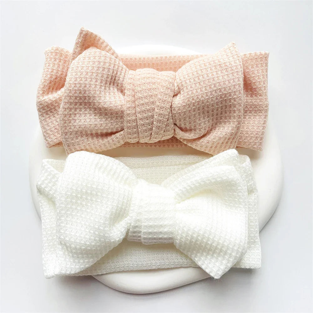 Lavender baby girl's cotton bow headband, a gentle infant headwear choice