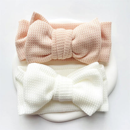 Lavender baby girl's cotton bow headband, a gentle infant headwear choice