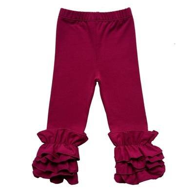 Close-up of the delicate ruffle detail on pink cotton baby girl leggings, soft fabric