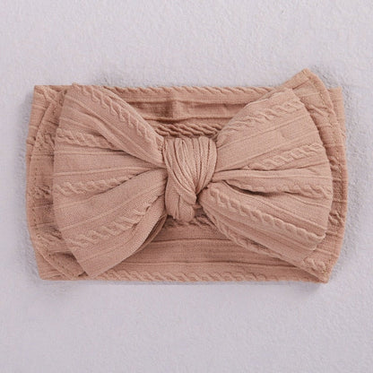 White soft elastic bow headband for a baby, elegant newborn fashion item