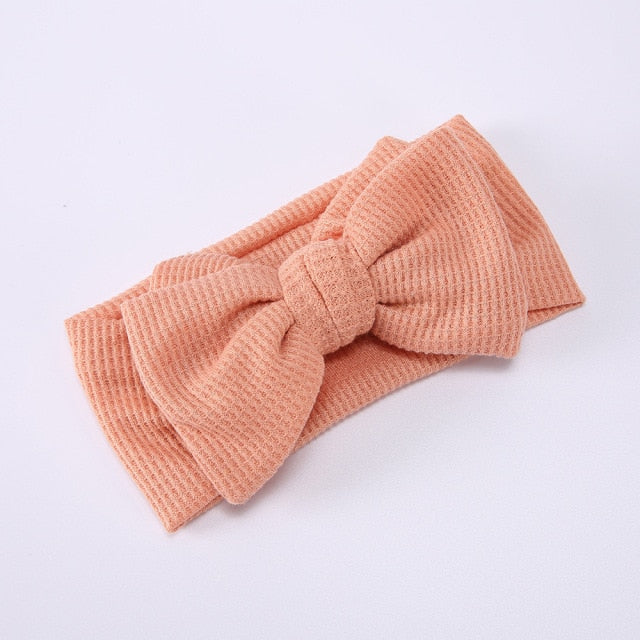 White elastic bow headband for baby girls, ideal for newborn baby fashion